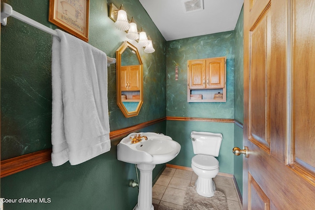 bathroom with toilet and tile patterned flooring