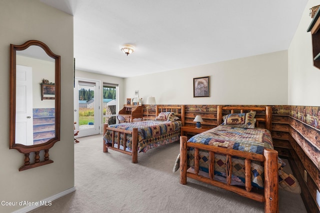 bedroom with carpet floors and access to exterior