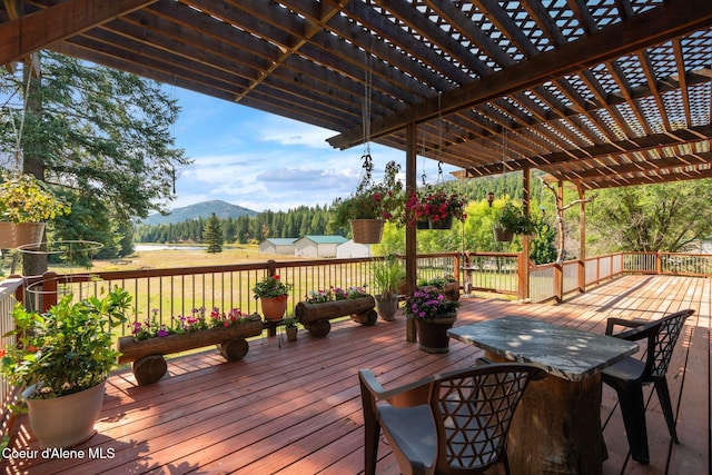 wooden deck with a mountain view and a pergola