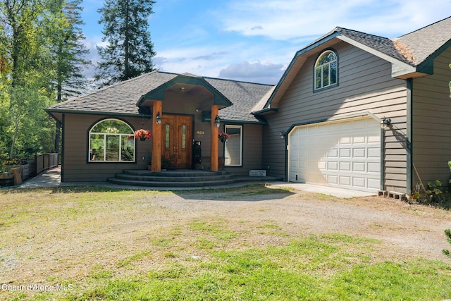 view of front of home featuring a garage and a front lawn