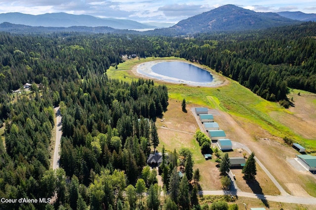 drone / aerial view featuring a water and mountain view