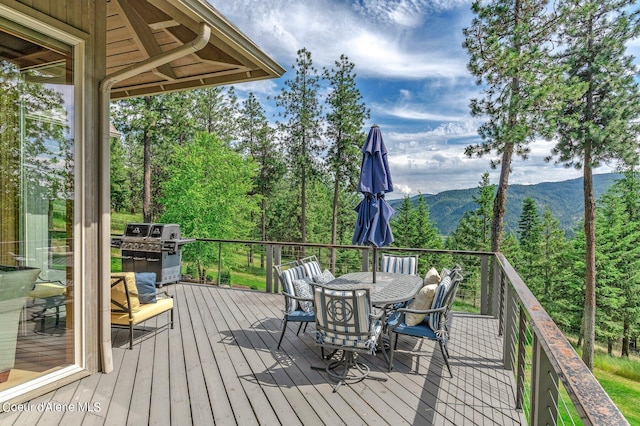 wooden terrace featuring a mountain view and grilling area