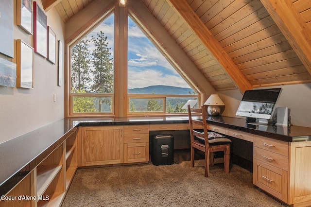 carpeted office featuring wooden ceiling, built in desk, and vaulted ceiling with beams