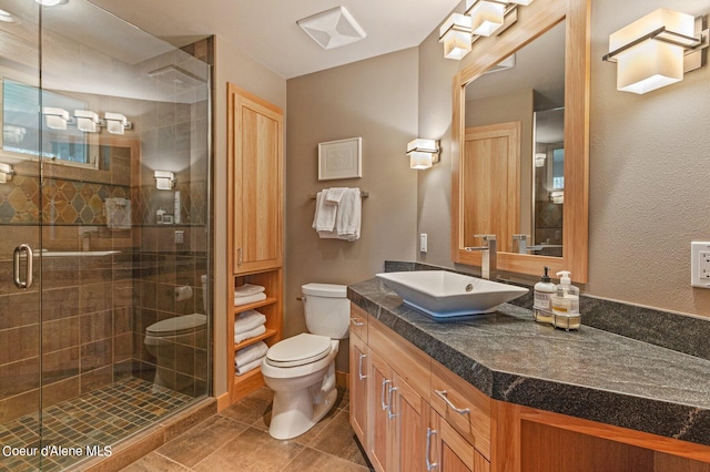 bathroom with vanity, toilet, an enclosed shower, and tile patterned flooring