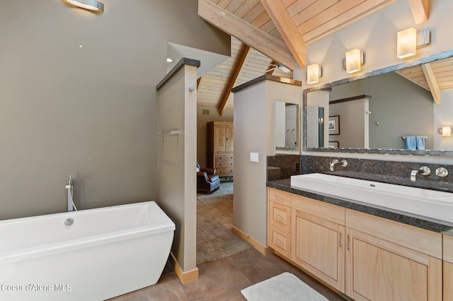 bathroom featuring tile patterned flooring, vanity, lofted ceiling with beams, wooden ceiling, and a bathing tub