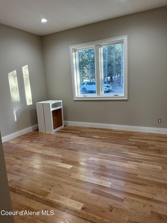 empty room with light hardwood / wood-style flooring