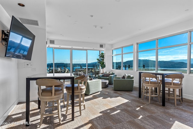 interior space with a water and mountain view