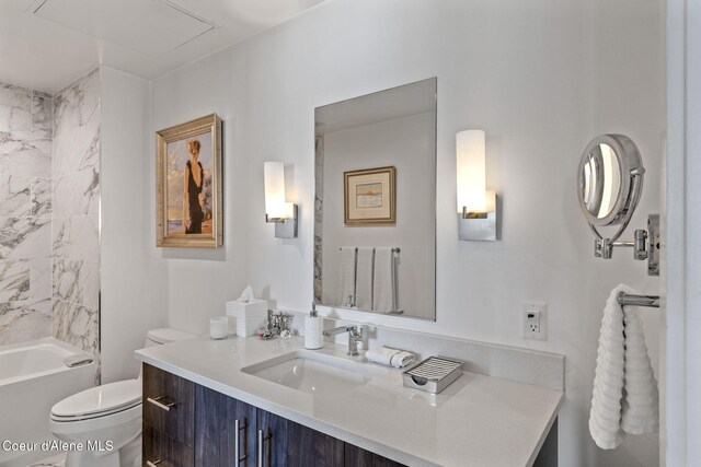 full bathroom featuring tiled shower / bath, vanity, and toilet