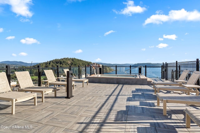 view of patio with a water and mountain view