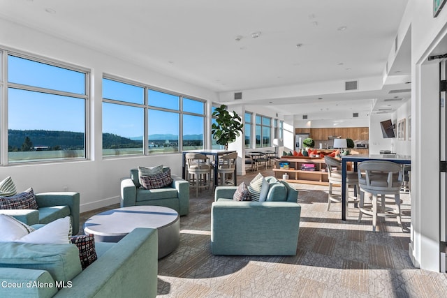 living room featuring a water view and dark wood-type flooring