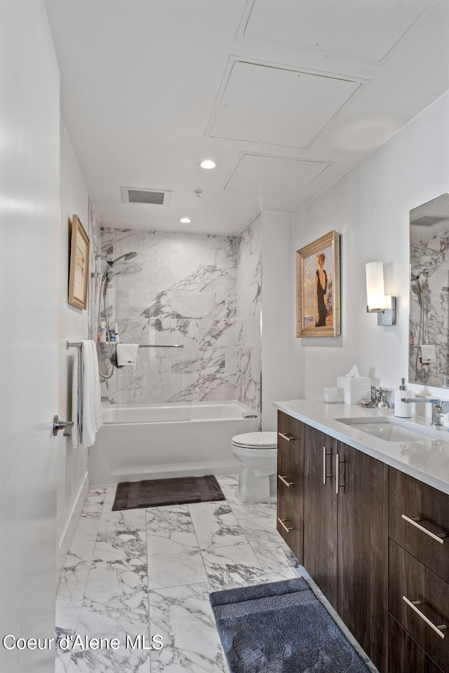 full bathroom with vanity, tiled shower / bath combo, and toilet