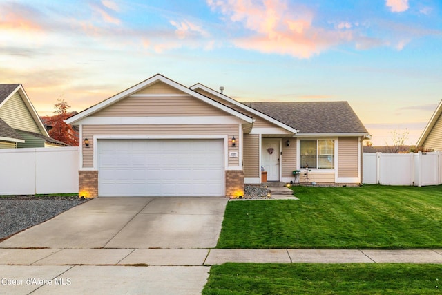 view of front of house with a garage and a lawn