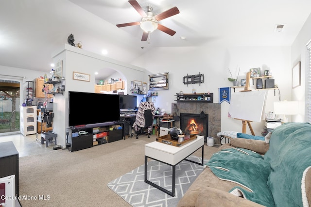 carpeted living room with ceiling fan and vaulted ceiling