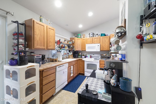 kitchen featuring sink, white appliances, and vaulted ceiling