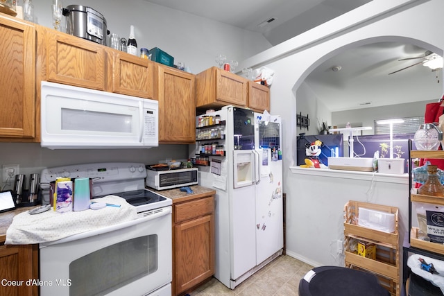 kitchen featuring ceiling fan and white appliances