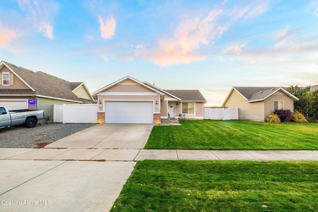 ranch-style house with a garage and a lawn