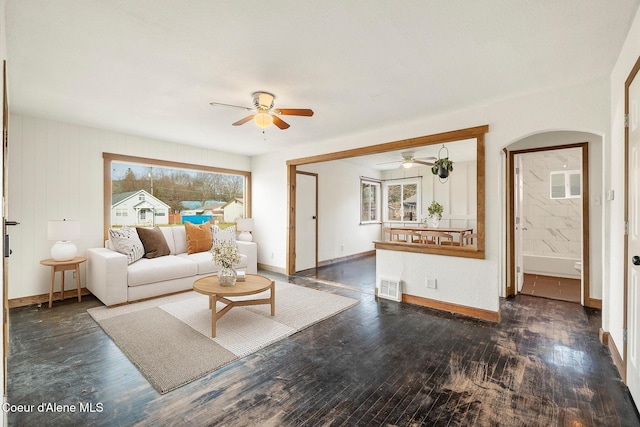 living room featuring dark hardwood / wood-style flooring and ceiling fan