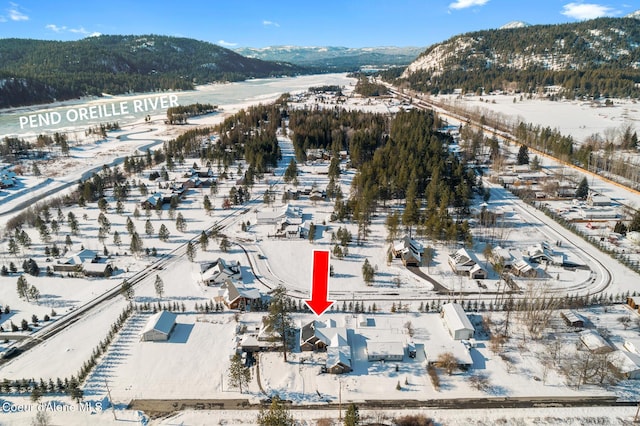 snowy aerial view featuring a mountain view