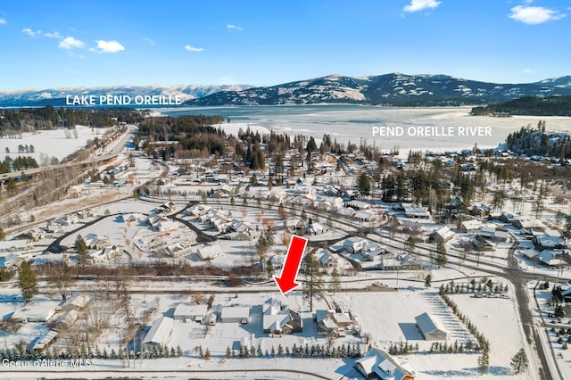 snowy aerial view featuring a mountain view