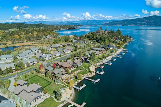 drone / aerial view with a water and mountain view