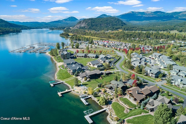 drone / aerial view featuring a water and mountain view