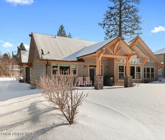 view of snow covered rear of property