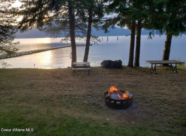 view of water feature with a fire pit