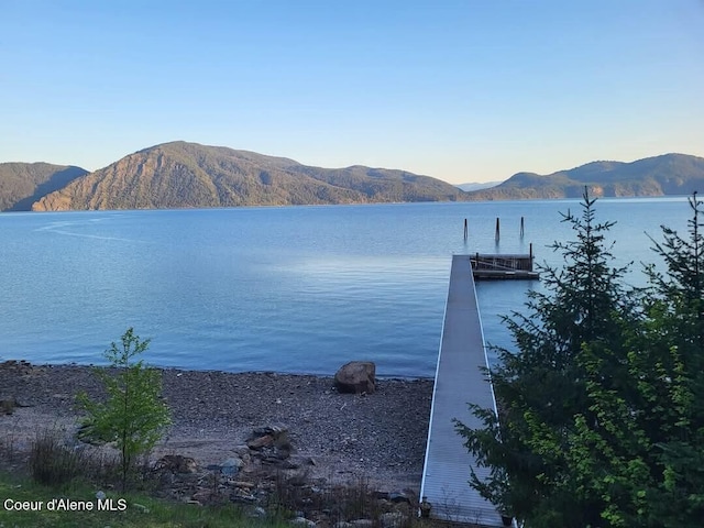 view of dock featuring a water and mountain view