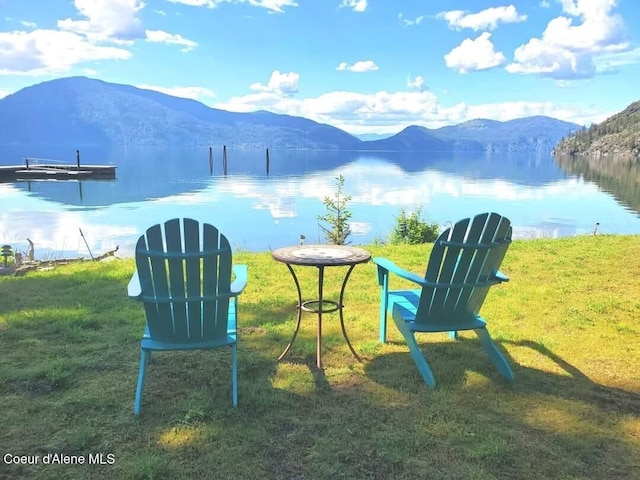 water view with a mountain view and a boat dock