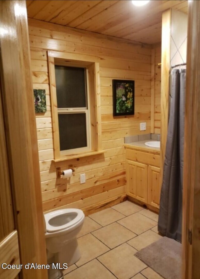 bathroom featuring tile patterned flooring, toilet, wooden ceiling, and wood walls