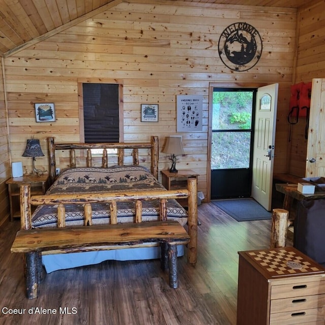 bedroom featuring wood ceiling, dark hardwood / wood-style flooring, vaulted ceiling, and wood walls