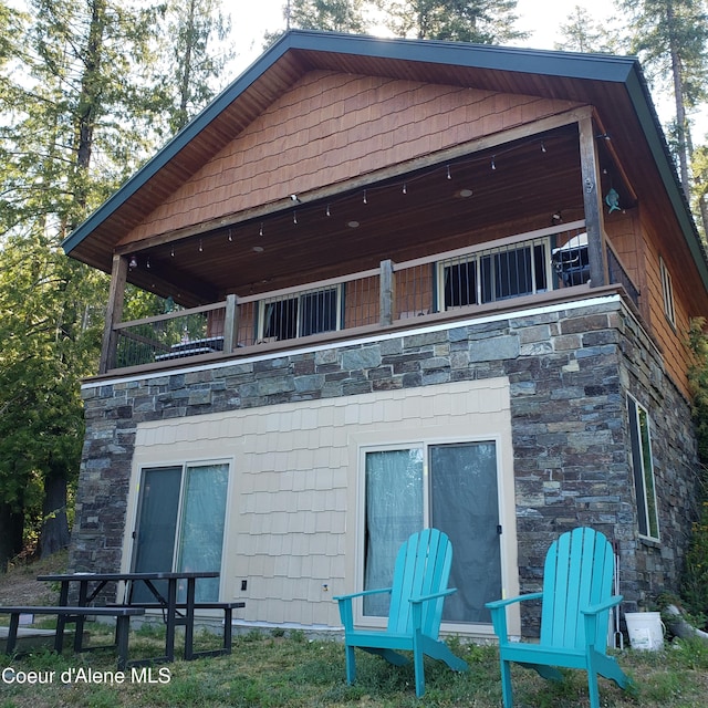 rear view of property featuring a balcony