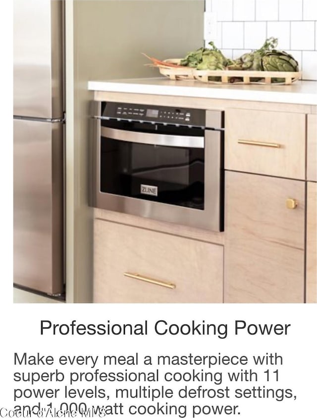 kitchen featuring stainless steel appliances, light brown cabinetry, decorative backsplash, and light countertops