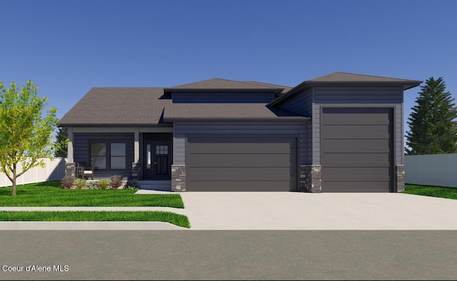 prairie-style home featuring driveway, stone siding, fence, a front yard, and a garage