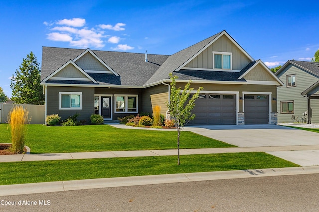 craftsman-style house featuring a garage and a front lawn