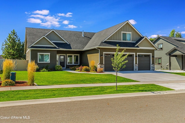 craftsman house with a garage and a front lawn