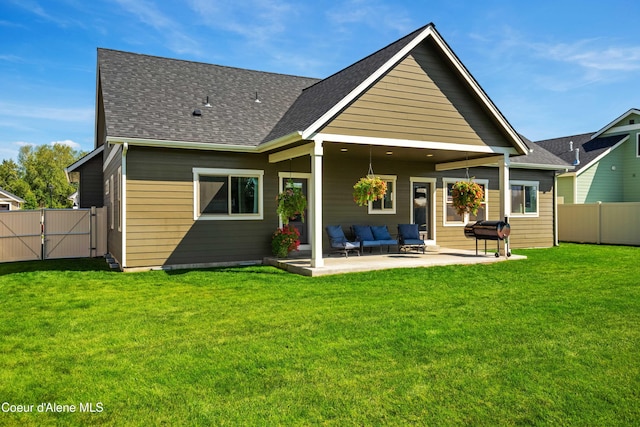 back of house with an outdoor living space, a yard, and a patio area