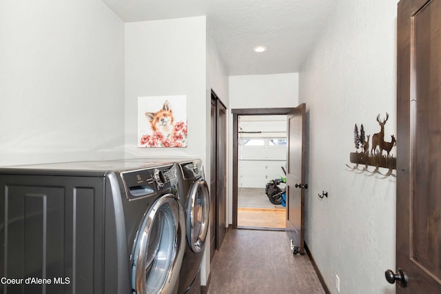 laundry room with washing machine and clothes dryer and hardwood / wood-style floors