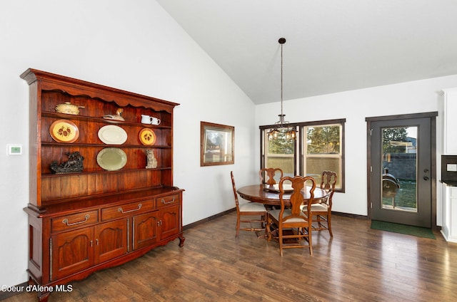 dining area with an inviting chandelier, dark wood-type flooring, and high vaulted ceiling