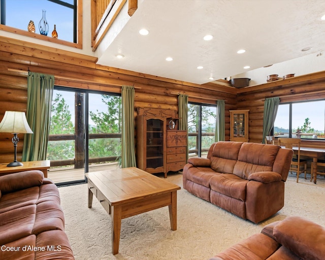 living room with a towering ceiling and light colored carpet