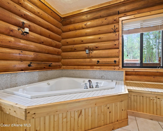 bathroom featuring tile patterned floors and a washtub