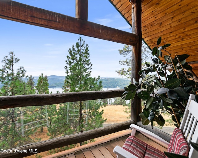 wooden terrace featuring a water view