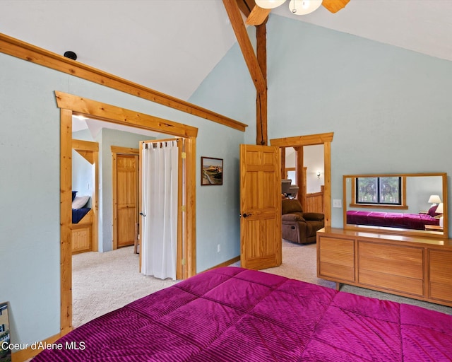 bedroom with light colored carpet and high vaulted ceiling