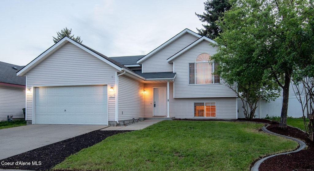 view of front of house featuring a garage and a front lawn