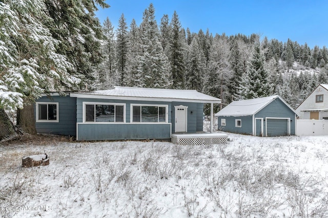 ranch-style home with a garage and covered porch