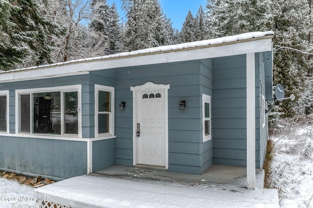 view of snow covered property entrance