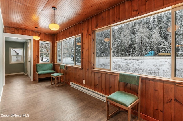 sunroom featuring a baseboard radiator and wooden ceiling