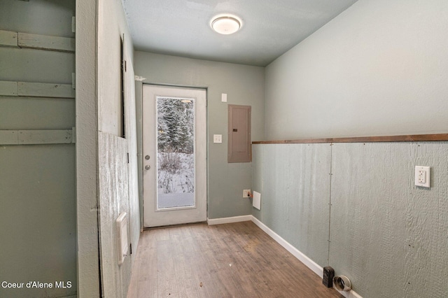 doorway to outside with electric panel and hardwood / wood-style floors