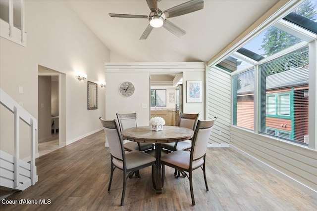 dining room with lofted ceiling, hardwood / wood-style flooring, and ceiling fan