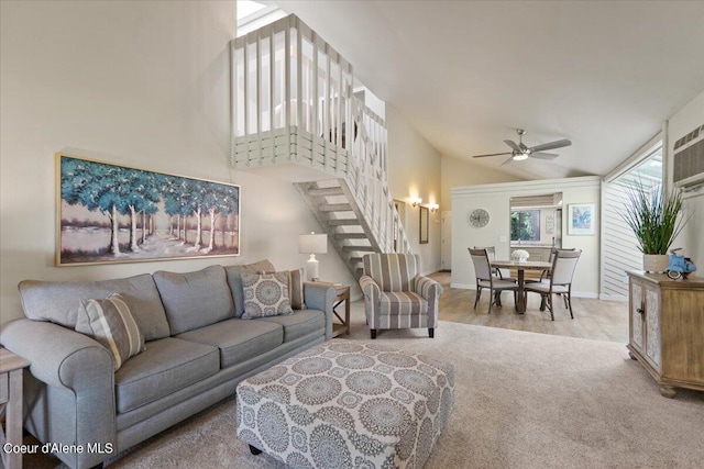 carpeted living room with high vaulted ceiling and ceiling fan